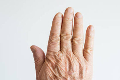 Elderly senior man's hands in front of a white background